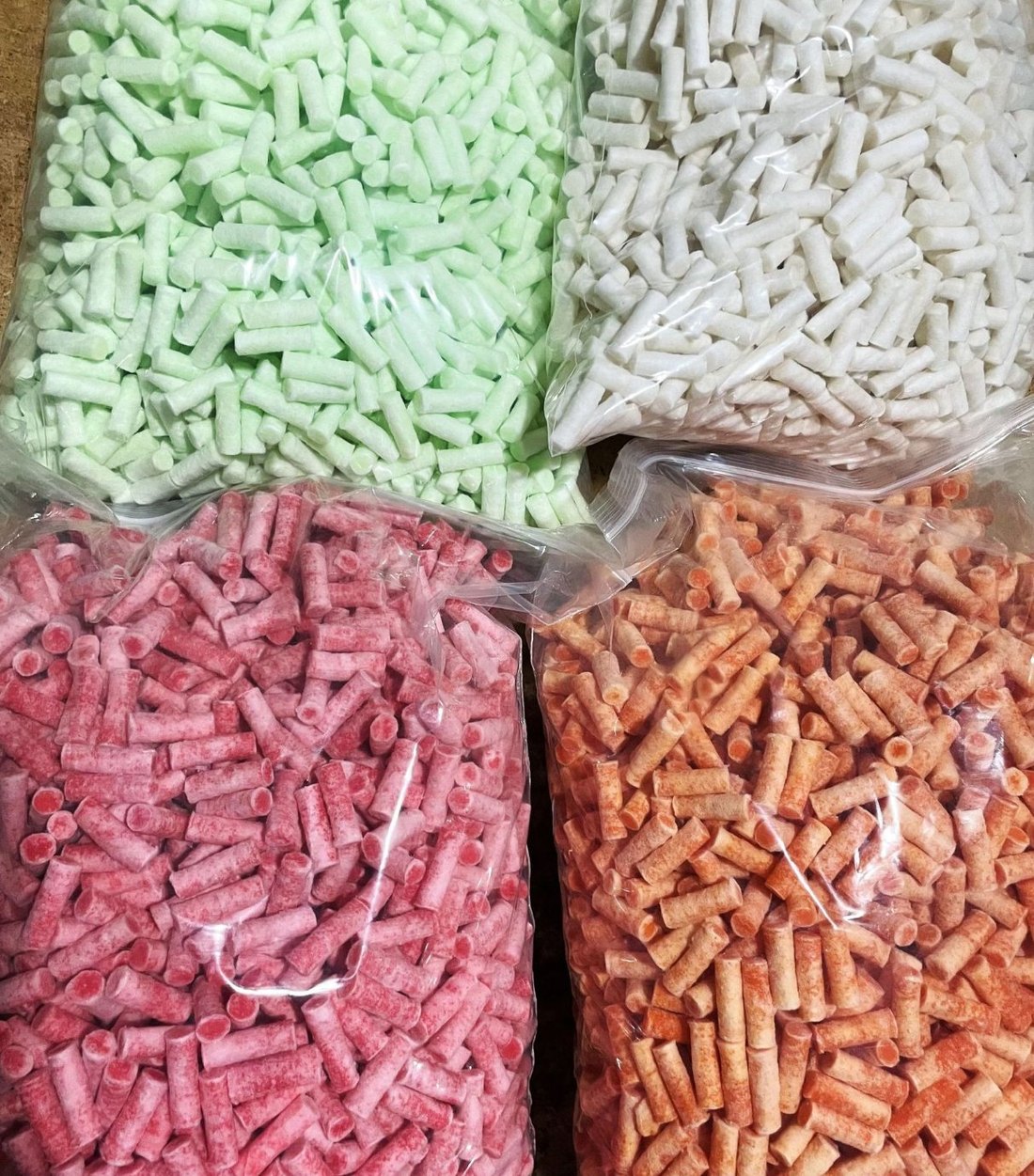 Firelighter pellets bulk-packed in clear bags, in four colours