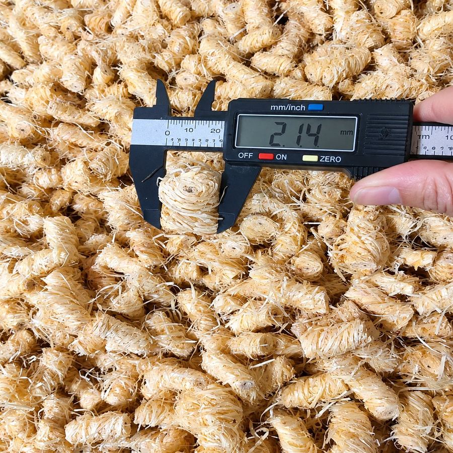 Checking the dimensions of an individual firelighter Caliper measuring the diameter of a single wood wool firelighter